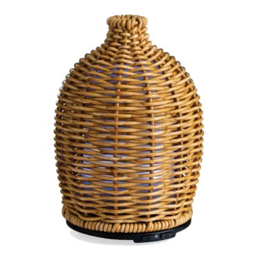 The Wicker Vase Medium Diffuser has a matte wicker that is tightly woven into a beautiful sleeve, giving off a subtle glow when in use. This diffuser brings a natural warmth to your space with organic, earthy textures and neutral tones.